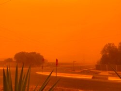 This picture taken and released courtesy of Petra Johansson, Nov. 21, 2019, shows the orange ski from dust storms caused by bushfires in Mildura in Victoria state.