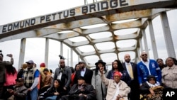 The foot soldiers are helped across the Edmund Pettus bridge during the 60th anniversary of the march to ensure that African Americans could exercise their constitutional right to vote, March 9, 2025, in Selma, Ala.