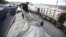 A member of Hamas security forces checks a truck loaded with gravel at the Kerem Shalom crossing between Israel and the southern Gaza Strip, December 30, 2012. 