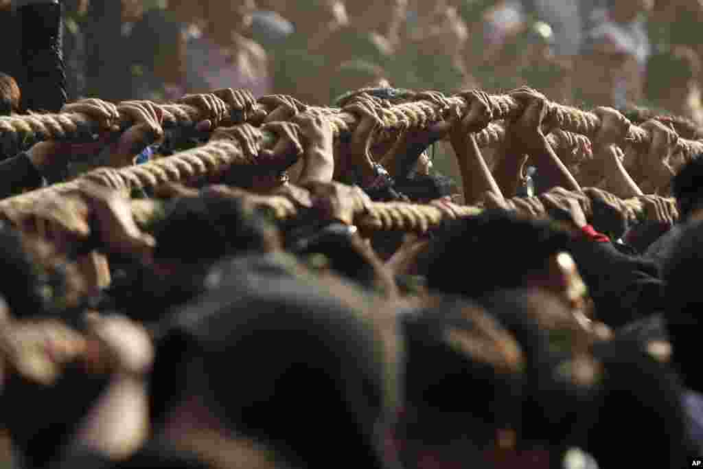 Nepalese devotees pull ropes tied to the chariot of Hindu god Bhairava during Biska Jatra Festival in Bhaktapur.