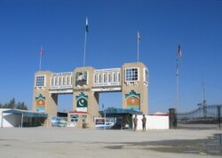 FILE - Paramilitary soldiers stand by the Friendship Gate crossing point at the Pakistan-Afghanistan border town of Chaman, March 2, 2020.