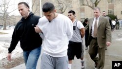 FILE - In this Jan. 11, 2018, photo, suspected members of the MS-13 gang are escorted to their arraignment in Mineola, N.Y.