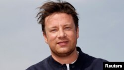 Chef Jamie Oliver poses during a photocall at the annual MIPCOM television program market in Cannes, France, Oct. 15, 2018. 