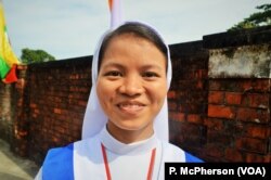 Sister Lucy, 22, outside Kyaikksan sports ground in Yangon following the papal mass.