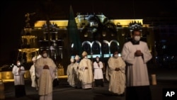 Priests walk towards Lima's Cathedral before the start of a Mass dedicated to Peru's more than 30,000 COVID 19 victims Nov. 1, 2020. 