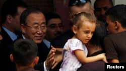 United Nations chief Ban Ki-moon greets a Palestinian man, whose house was destroyed, at a UN-run shelter for Gaza City refugees on Oct. 14, 2014.