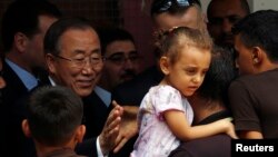 United Nations chief Ban Ki-moon greets a Palestinian man, whose house was destroyed, at a UN-run shelter for Gaza City refugees on Oct. 14, 2014.