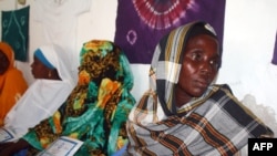 FILE - Hawo Jibril Ahmed (R), a former rape victim sits with other Somali women, inside the Somali women development center in Mogadishu, Dec. 31, 2012.