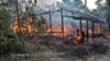 A Maungda hut burning in Western Myanmar. (Photo: Steve Sandford / VOA)