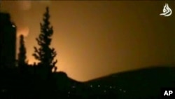 In this image taken from video obtained from Shaam News Network, which has been authenticated based on its contents and other AP reporting, smoke and fire fill the skyline over Damascus, Syria, early Sunday, May 5, 2013 after an Israeli airstrike.