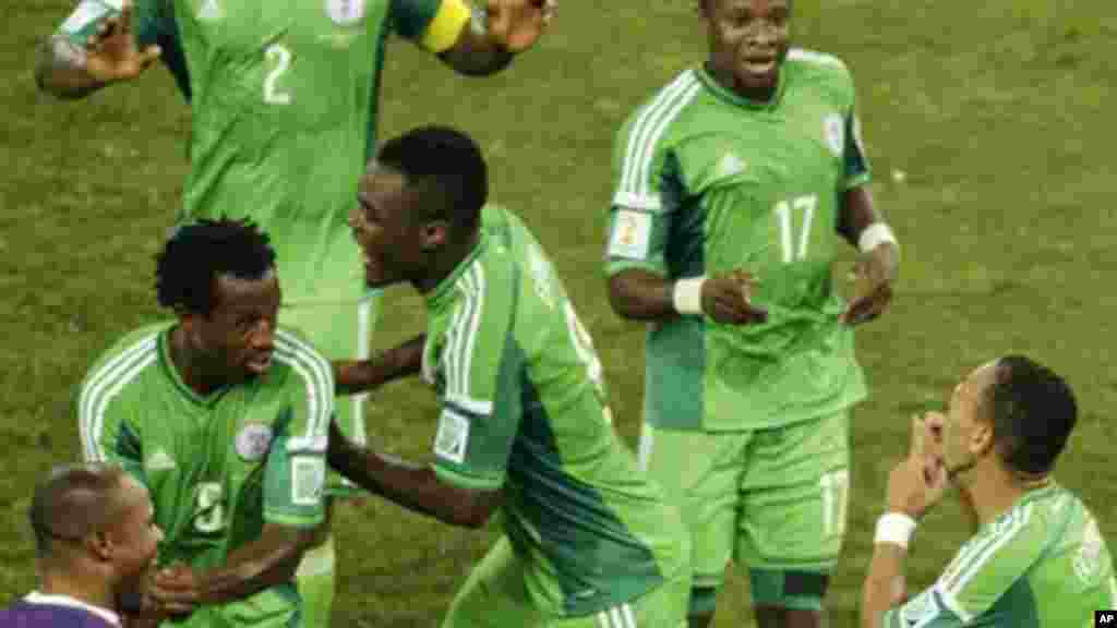 Nigeria's Peter Odemwingie, right, celebrates with his teammates after scoring the opening goal.