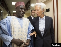 International Monetary Fund Managing Director Christine Lagarde (R) walks with Cameroon's Minister of Finance Alamine Ousmane Mey after their meeting at the Ministry of Finance in Yaounde, Cameroon, in this Jan. 7, 2016 handout photo by IMF.