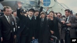 FILE - The Beatles, from left, John Lennon, Paul McCartney, Ringo Starr and George Harrison, arrive at John F. Kennedy International Airport in New York, on Feb. 7, 1964. 