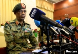 FILE - Major General Awad Mohamed Ahmed Ibn Auf, who was to lead a military council to run Sudan over the next two years, speaks to the media, in Khartoum, Sudan, Feb. 24, 2019.