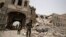 FILE - Shiite rebels, known as Houthis, stand guard in front of Yemen's Defense Ministry building in Sanaa, Yemen on June 10, 2015, after it was damaged by Saudi-led airstrikes. 