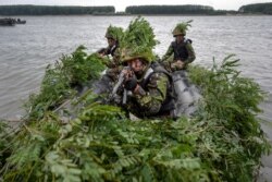 FILE - Romanian soldiers take part in a joint exercise with U.S. troops during Argedava Saber 17, a stage in Saber Guardian 17 exercises, in Bordusani, Ialomita, Romania, July 16, 2017.