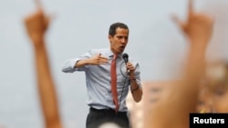 Venezuelan opposition leader Juan Guaido, who many nations have recognised as the country's rightful interim ruler, gestures as he speaks during a protest against Venezuelan President Nicolas Maduro's government in Caracas, Venezuela, March 12, 2019.