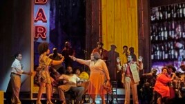 This September 17, 2021 image released by the Metropolitan Opera shows Latonia Moore as Billie, center, and the cast during a rehearsal for Terence Blanchard's 