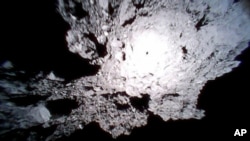 This Oct. 26, 2018, image captured by Rover-1A, and provided by the Japan Aerospace Exploration Agency (JAXA) on Thursday, Dec. 13, 2018, shows the surface of asteroid Ryugu. (JAXA via AP)