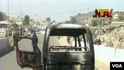Para perusuh membakar sebuah mobil van di kota Jos, dalam kerusuhan saat Natal sebulan lalu.