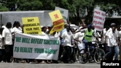 FILE - Supporters of the Zimbabwe African National Union's Patriotic Front (ZANU-PF) march in Harare, Feb. 24, 2010, to protest a European Union decision to extend economic sanctions on Zimbabwe.