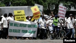FILE - Supporters of the Zimbabwe African National Union's Patriotic Front (ZANU-PF) march in Harare, Feb. 24, 2010, to protest against a European Union decision to extend economic sanctions on Zimbabwe.