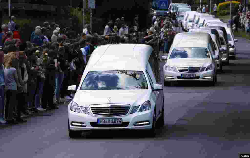Hearses carrying coffins with remains of victims of the Germanwings flight 4U 9525 plane disaster drive past the Joseph-Koenig-Gymnasium high school in Haltern am See, Germany. Forty four coffins with the victims' remains from the crash on March 24 were flown from France to Germany.