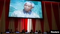 A previous address to the United Nations by former South African President Nelson Mandela is shown on a video screen during an informal meeting of the plenary of the General Assembly to commemorate Nelson Mandela International Day at the United Nations headquarters in New York, July 18, 2013. 