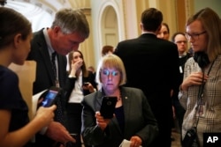 Sen. Patty Murray, D-Wash., looks at a cellphone while speaking with a journalist after she and other members of the Senate Democratic leadership spoke to reporters about health care on Capitol Hill in Washington, May 9, 2017.