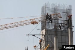 Laborers work at a construction site in Phnom Penh, Cambodia, Jan. 29, 2019.