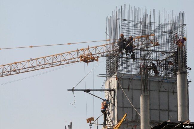 Laborers work at a construction site in Phnom Penh, Cambodia, Jan. 29, 2019.