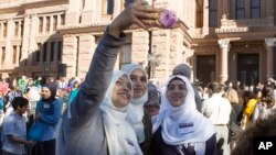 Mussarrat Rehman, from left, Rida Syed and Sadaf Karim take a selfie during Texas Muslim Capitol Day, Jan. 31, 2017, at the Texas Capitol in Austin, Texas. 