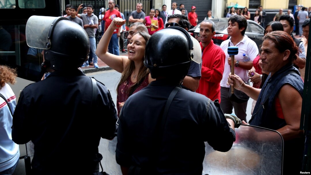 Supporters of political leader Keiko Fujimori wait outside the prosecutor's office while she responds to questions regarding the Odebrecht corruption case, in Lima, Peru, Dec. 28, 2017.