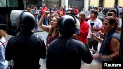 Supporters of political leader Keiko Fujimori wait outside the prosecutor's office while she responds to questions regarding the Odebrecht corruption case, in Lima, Peru, Dec. 28, 2017.