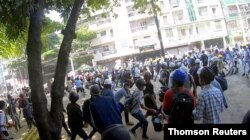 Manifestantes corren huyendo de las balas, en Yangon, Myanmar, el 8 de marzo de 2021.