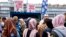 Young women, many wearing headscarves, listen to a party member of the right-wing Sweden Democrats in Stockholm, Sweden, Aug. 31, 2018. 