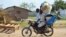 A couple flees on motorbike from the Jabel area of Juba, South Sudan, July 16, 2016. The United Nations refugee agency reports 26,000 fearful people have left the country this month.