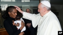 In this photo provided by the Vatican newspaper L'Osservatore Romano, Pope Francis meets Meriam Ibrahim, from Sudan, with her daughter Maya in her arms, at the Vatican, July 24, 2014.