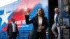 TOPSHOT - Democratic presidential candidate US Vice President Kamala Harris and her running mate, Minnesota Governor Tim Walz, disembark from their campaign bus in Savannah, Georgia, August 28, 2024, as they travel across Georgia for a 2-day campaign bus 