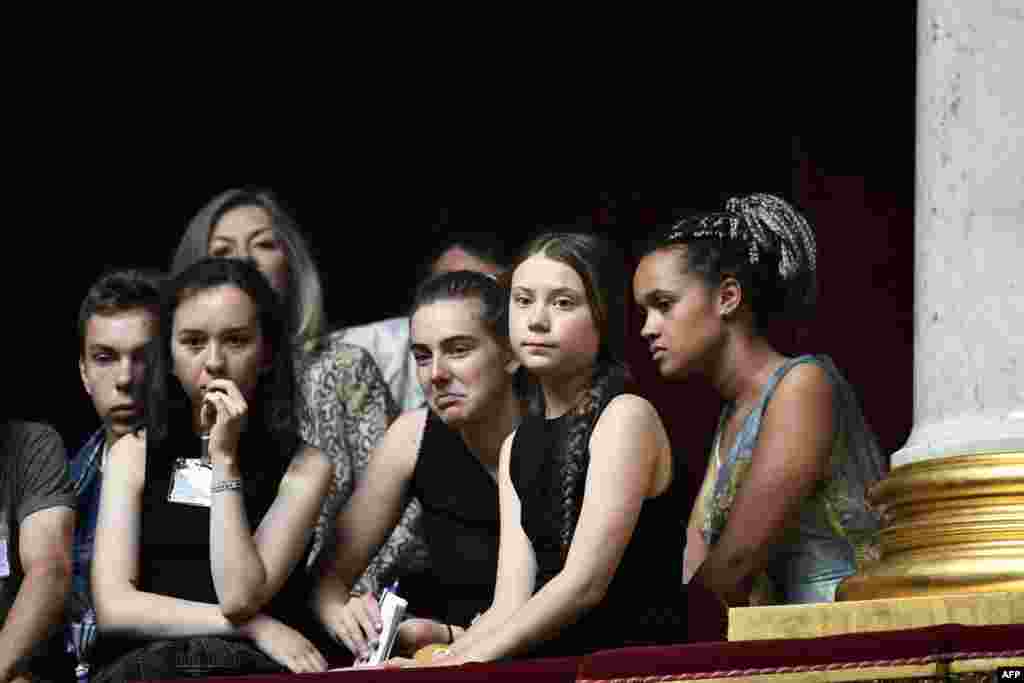 Swedish climate activist Greta Thunberg (second from the right) attends a session of questions to the government at the French National Assembly in Paris after an earlier speech earlier.