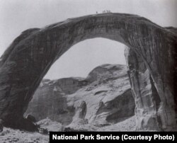 The massive stone 'rainbow' dwarfs the members of a government expedition to the arch in the first decade of the 20th century.