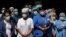 Health care workers gather for lunch purchased by members of the New York City Police Department (NYPD) outside the Brooklyn Hospital Center, during the outbreak of coronavirus disease (COVID-19) in the Brooklyn borough of New York City, April 28, 2020.