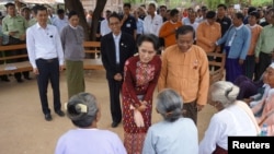 FILE - Myanmar's State Counsellor Aung San Suu Kyi talks to the elderly at a peace talk conference in May Tain Kan village, Wundwin, in Mandalay Division, Aug. 7, 2017. 