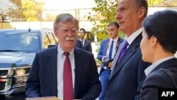 U.S. National Security Adviser John Bolton, left, and Russian Security Council chairman Nikolai Patrushev talk prior their official talks in Moscow, Oct. 22, 2018. (Press Service of the Russian Security Council via AP)
