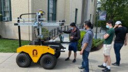 Students work together teaching an agricultural robot on the campus of Carnegie Mellon University in Pittsburgh.