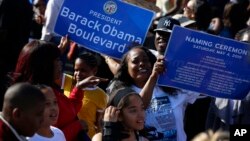 Citizens hold banners of a Obama Boulevard sign in Los Angeles, May 4, 2019. The Obama Boulevard will replace Rodeo Road, a 3 ½-mile street that runs across the city's historic black neighborhood.
