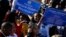 Citizens hold banners of a Obama Boulevard sign in Los Angeles, May 4, 2019. The Obama Boulevard will replace Rodeo Road, a 3 ½-mile street that runs across the city's historic black neighborhood.