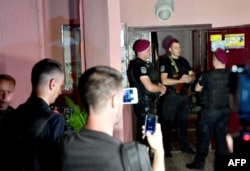Policemen stand guard at the entrance of an apartment building where Russian dissident journalist Arkady Babchenko was alleged to have been shot dead, in Kyiv, Ukraine, May 29, 2018.