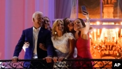 President Joe Biden poses for a photo with granddaughter Finnegan Biden, from left, first lady Jill Biden, granddaughter Naomi Biden and daughter Ashley Biden as they view fireworks during an Independence Day celebration on the South Lawn of the White Hou