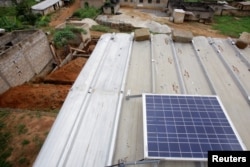 A solar panel is pictured on the roof of Jean-Noel Kouame's house, on the outer edge of Abidjan, Ivory Coast, Dec. 18, 2017.